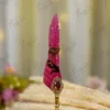 Detailed view of the gold-splattered red feather quill spine