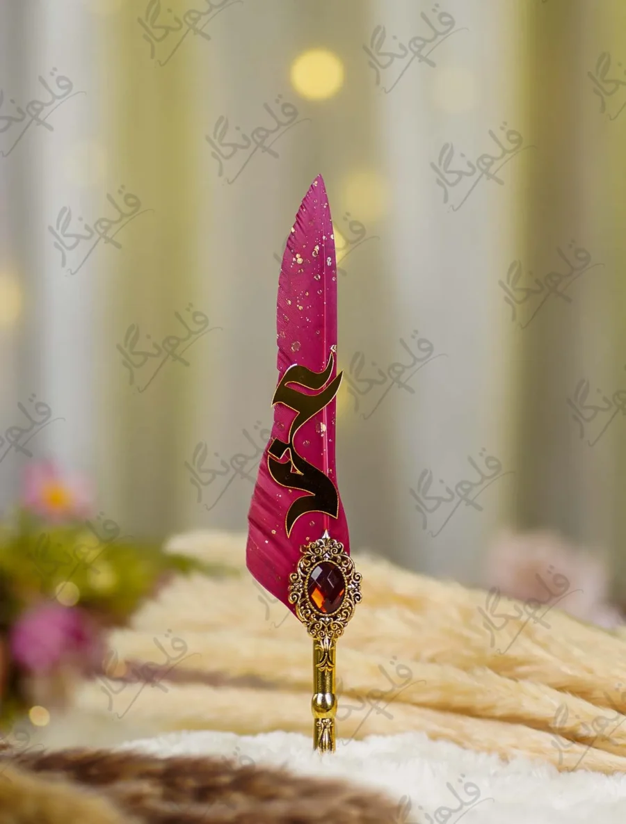Detailed view of the gold-splattered red feather quill spine
