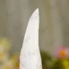Side angle of the golden owl emblem perched on the pen body