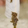 High angle view of the golden owl sculpture showing rhinestone eyes