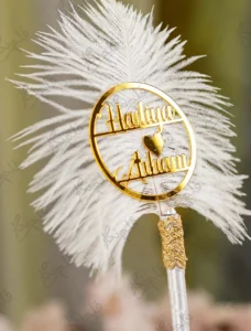 Personalized version of the white feather Nikkah pen showing gold mirror acrylic couple nameplate with heart