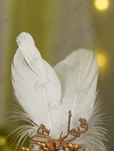 Detailed shot of the ivory fabric rose and wooden Qabool Hai cutout