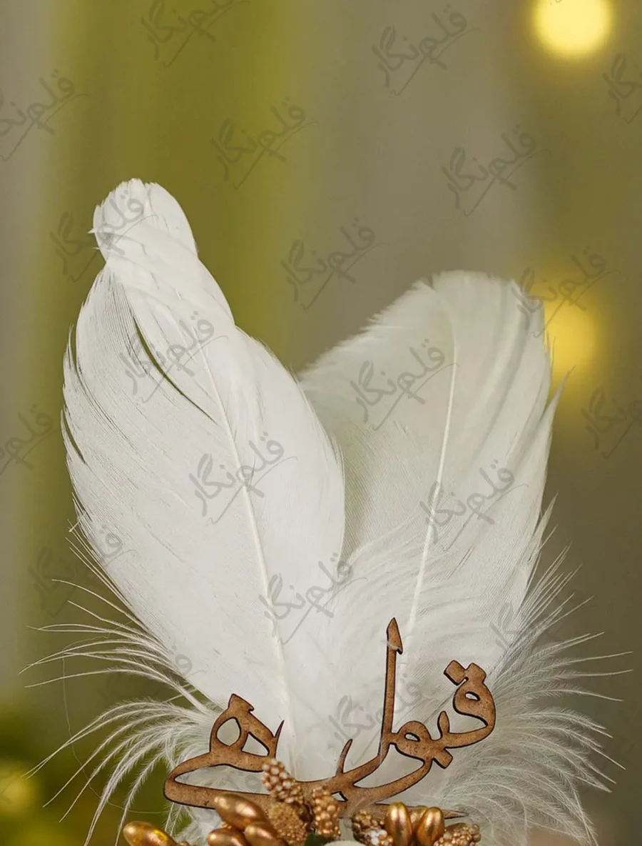 Detailed shot of the ivory fabric rose and wooden Qabool Hai cutout