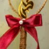 Detailed shot of the maroon satin bow with a center double pearl