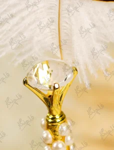 Detailed shot showing the vertical rows of white pearls on the gold handle