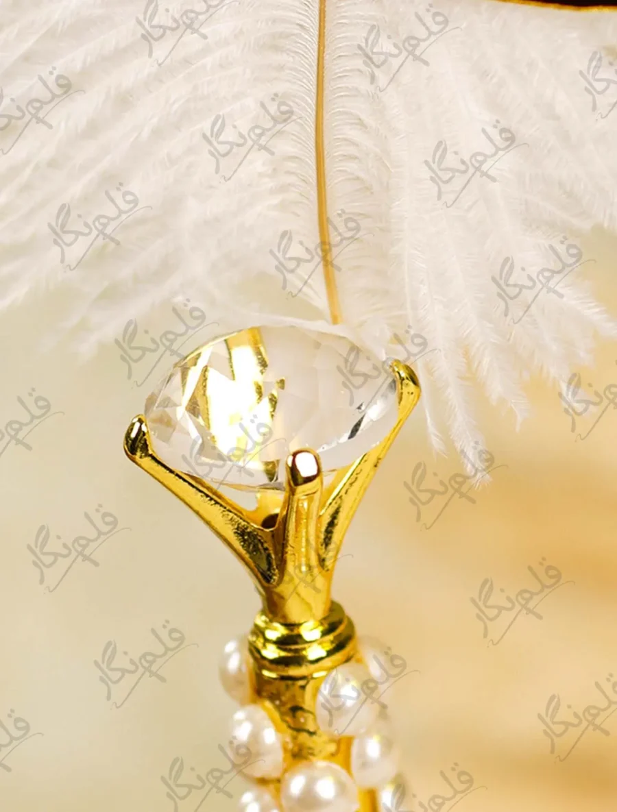 Detailed shot showing the vertical rows of white pearls on the gold handle
