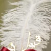 Detailed shot of the maroon satin ribbon bow and pearl rhinestone button center