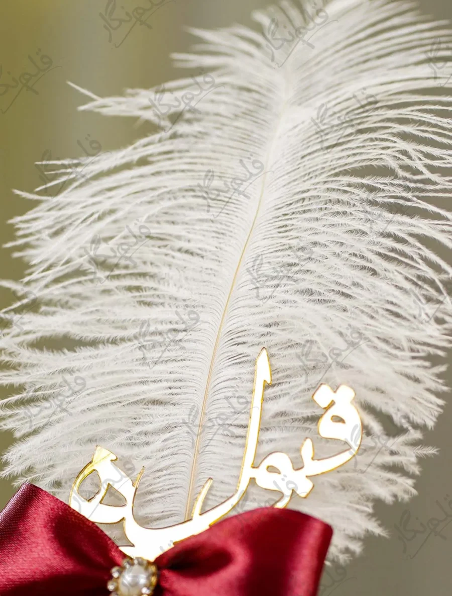 Detailed shot of the maroon satin ribbon bow and pearl rhinestone button center