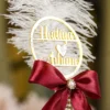 High angle close up of the maroon bow and gold mesh assembly