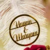 Customized version showing circular gold acrylic couple name circle on the feather