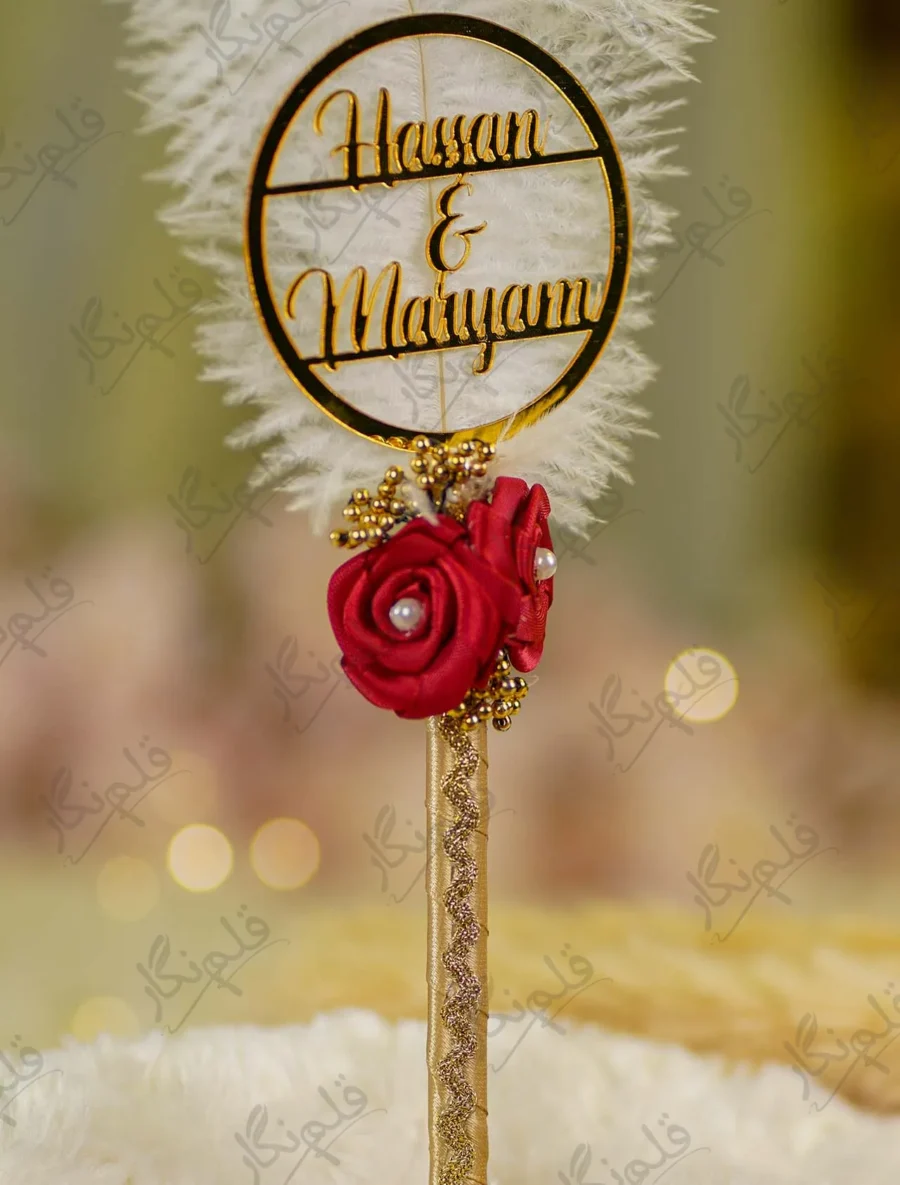Close up of the golden mirror acrylic Qabool Hai calligraphy on the feather
