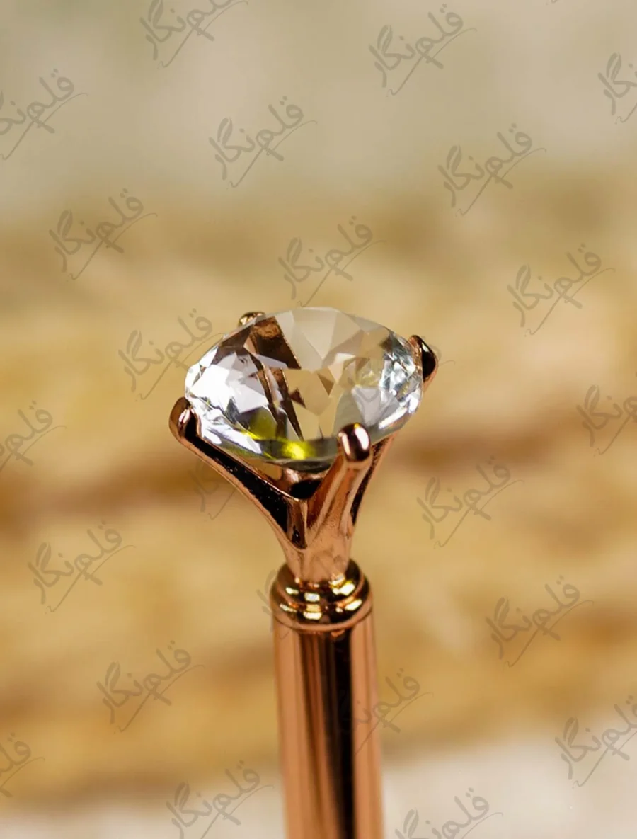 Close-up of the custom gold mirror acrylic calligraphy name cutout on the pen