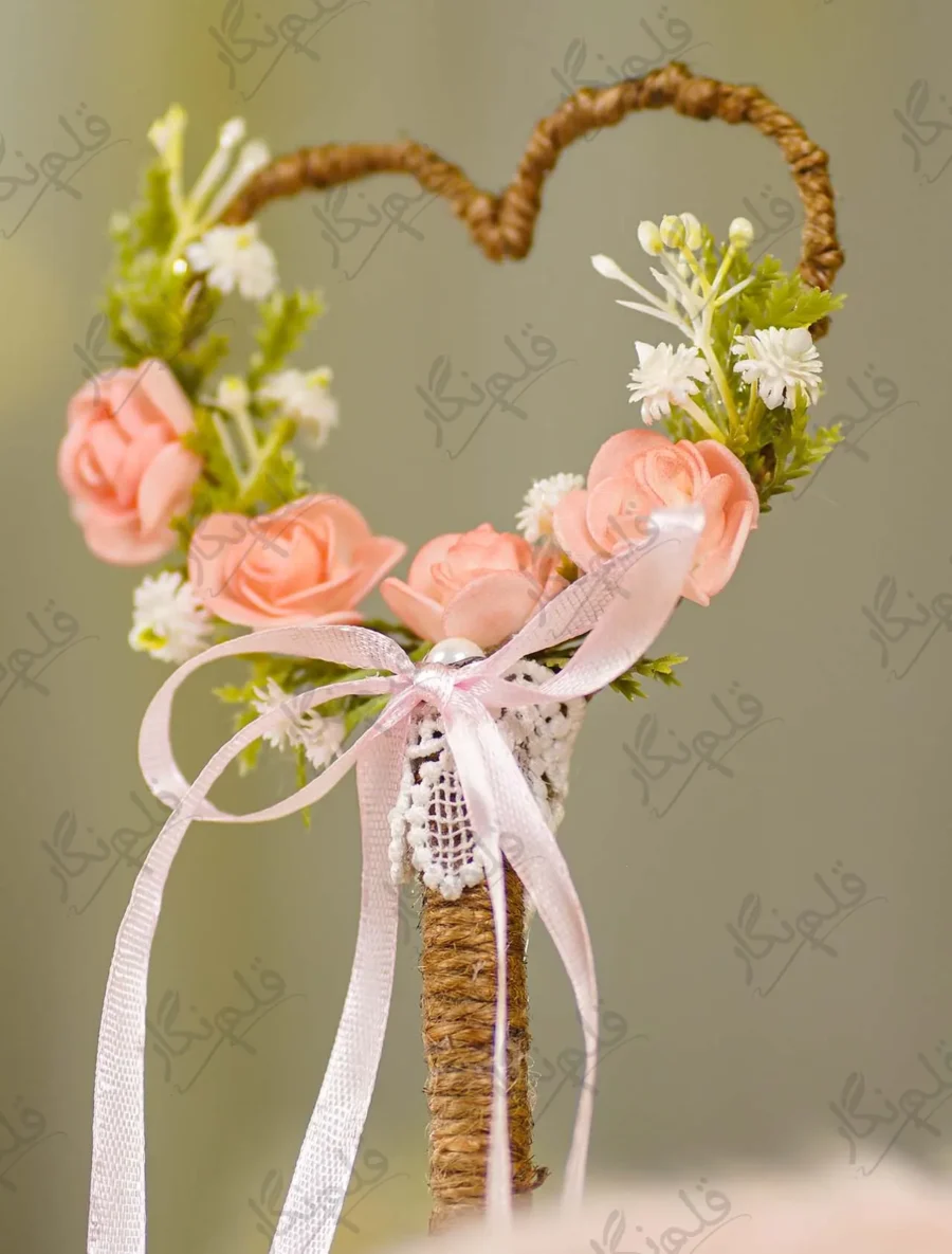 Close up of the artificial pink peach roses and baby's breath flowers on the heart frame
