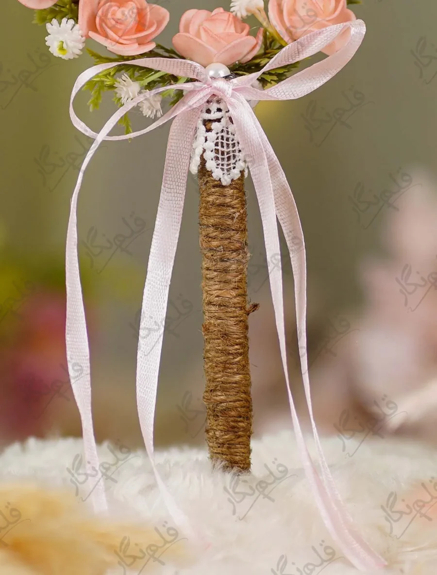 Detailed shot of the pink satin ribbon bow, white lace backing, and jute wrapping