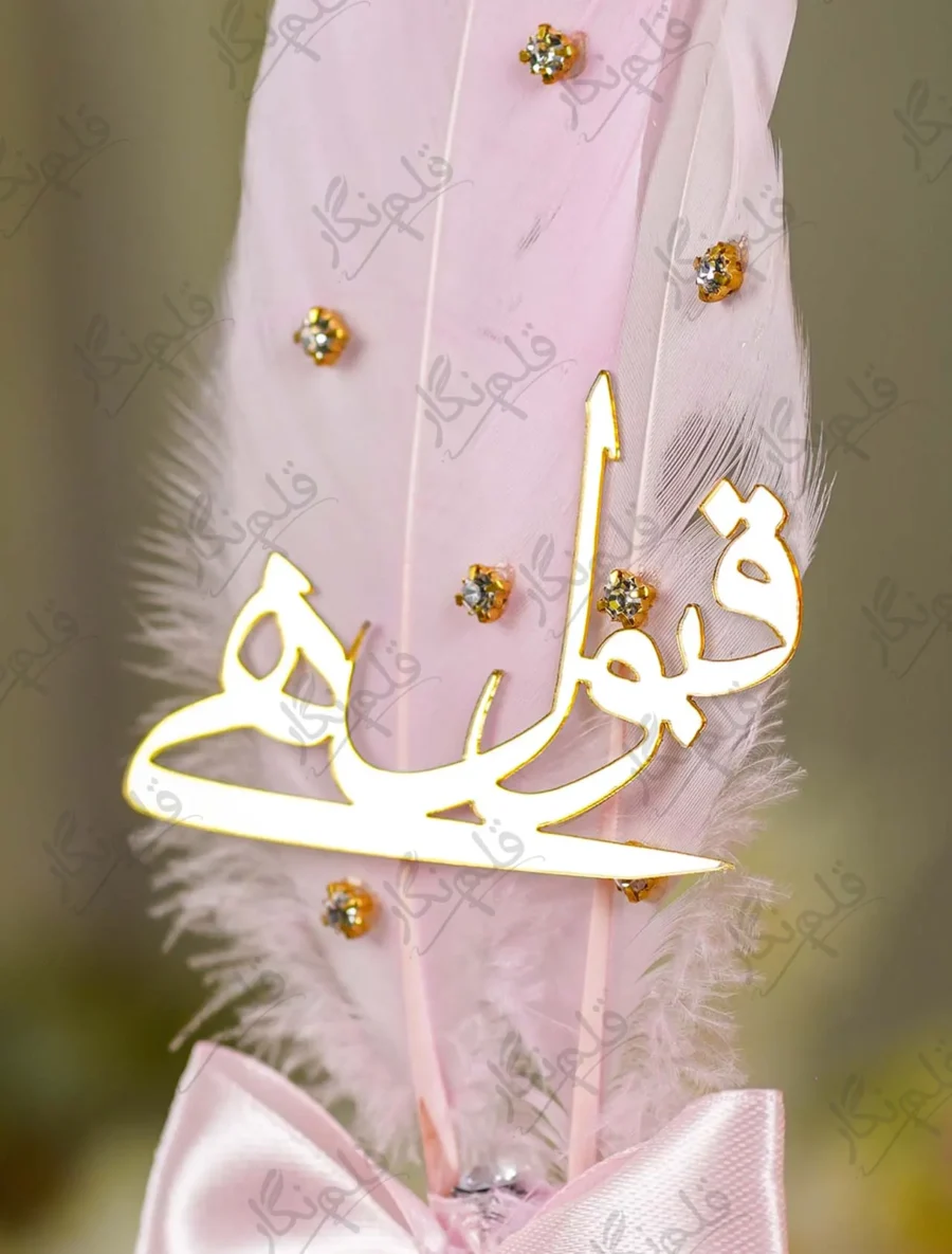 Detailed view of the gold claw-set rhinestones on the pink and white feathers