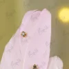 High angle close up of the crystals glued onto the light pink feather surface