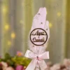 Side angle of the pink satin bow and gold rhinestone spiral wrapping on the handle