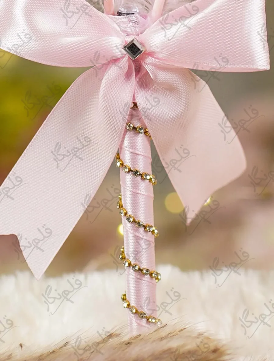 Elegant pink themed wedding signing pen lying on a soft white fur backdrop
