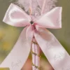 Close up of the light pink ribbon bow and rhinestone centerpiece