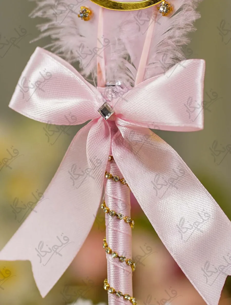 Close up of the light pink ribbon bow and rhinestone centerpiece