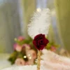 Handmade white feather Nikkah pen featuring a red rose flower and gold ribbon wrapped handle