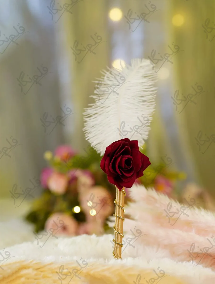 Handmade white feather Nikkah pen featuring a red rose flower and gold ribbon wrapped handle