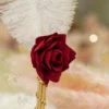 Close up of the red fabric rose at the base of the white feather on the signing pen