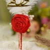 Side angle of the red rose and white feather on the wedding signing pen