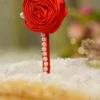 Elegant red themed Nikkah pen lying on a soft decorative fabric backdrop