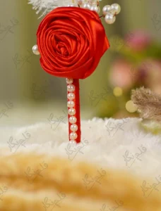Elegant red themed Nikkah pen lying on a soft decorative fabric backdrop