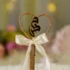 Front view of the gold mirror acrylic Qabool Hai script suspended in the jute wire heart