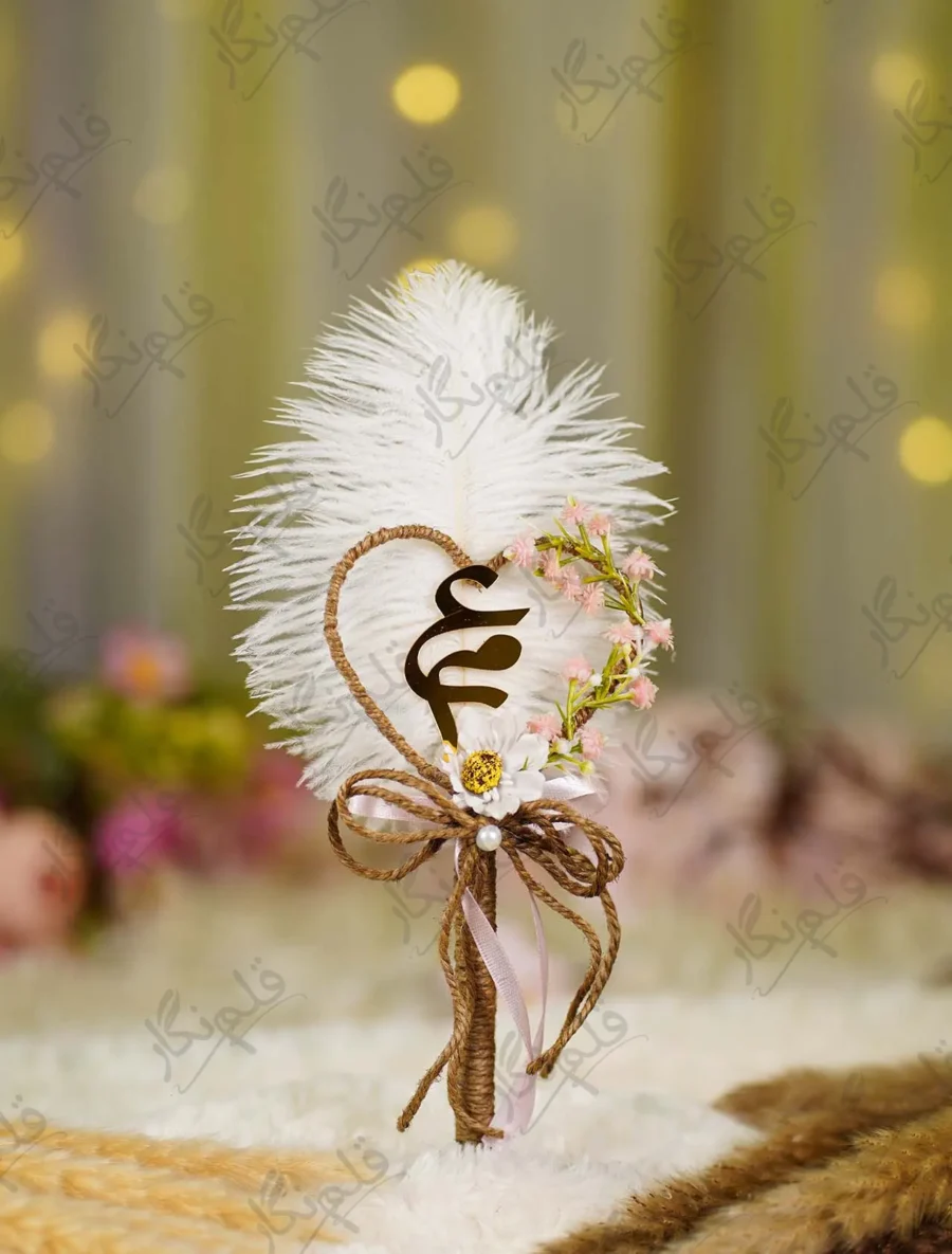 Close up of the golden mirror acrylic Qabool Hai calligraphy on the feather