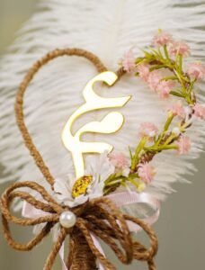 High angle shot of the pink flower vine curving on the jute heart