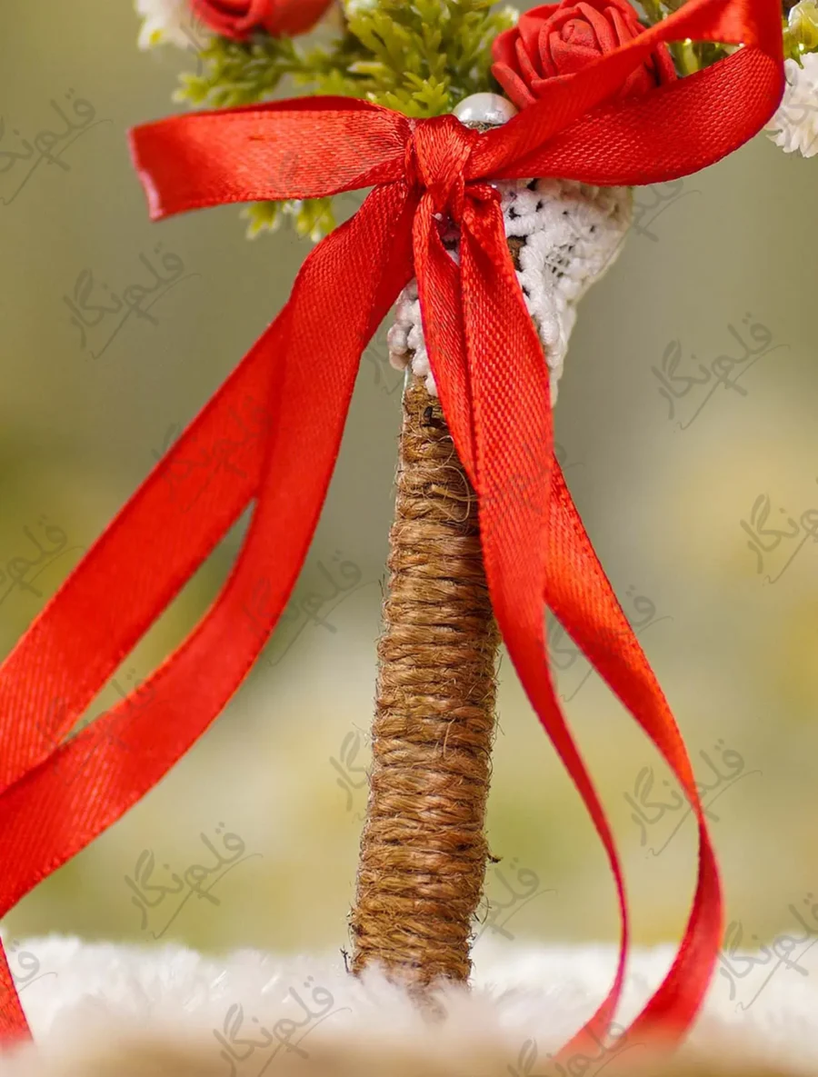 Detailed shot of the red satin ribbon bow, white lace backing, and jute wrapping