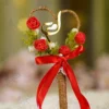 Side angle view of the red rose buds and green leaves on the wedding signing pen
