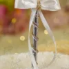Close up of the silver mirror acrylic Qabool Hai calligraphy on the feather