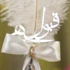 Detailed shot of the white ribbon bow and rhinestone knot embellishment