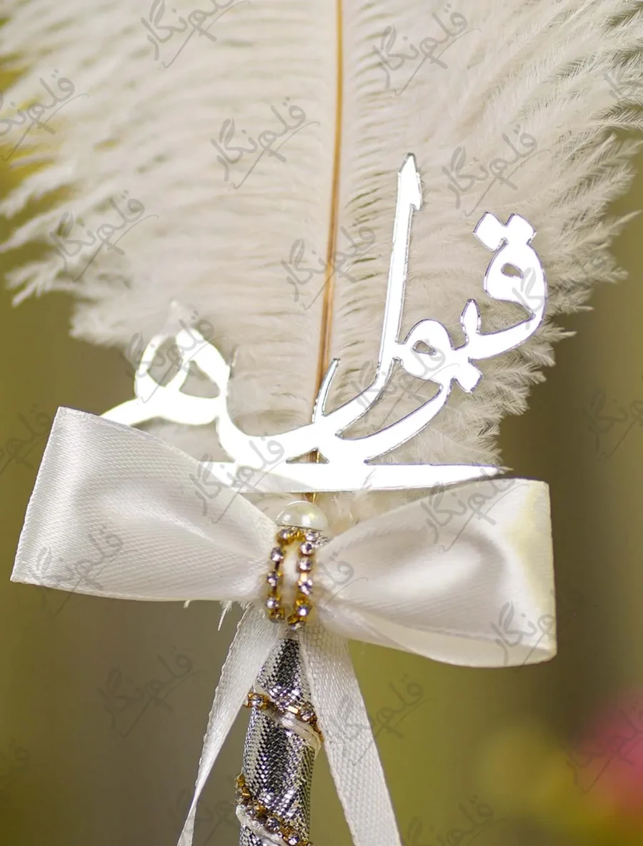 Detailed shot of the white ribbon bow and rhinestone knot embellishment