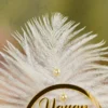 Alternate close up of the custom name circle and pearl-lined quill details