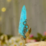 Imported gold metal Nikkah pen with a gold-splattered turquoise feather