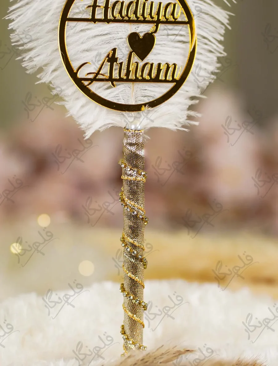 Elegant gold themed wedding signing pen lying on a soft white fur backdrop