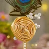 Close up of the golden mirror acrylic Qabool Hai calligraphy on the peacock feather