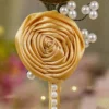 Detailed close up of the vertical row of white half pearls on the gold handle