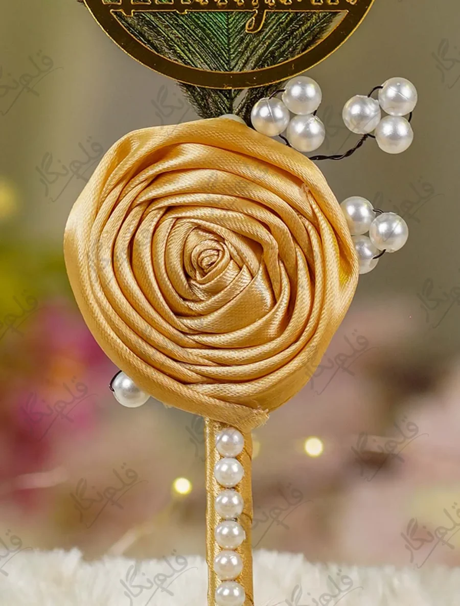 Detailed close up of the vertical row of white half pearls on the gold handle