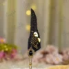Detailed shot of the gold mirror nameplate on black feather