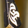 Upper half of the black feather showing gold dust paint splatters
