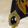Faceted black gemstone in an ornate gold frame detail