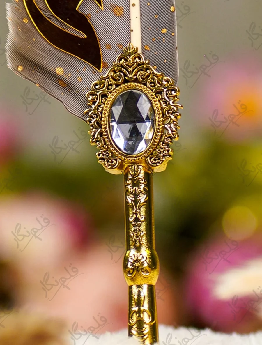Close up of the natural grey quill feather with gold dust flecks