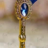 Side angle view of the blue feather showing gold paint spots