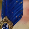 Detailed shot of the royal blue oval gemstone in the vintage gold frame